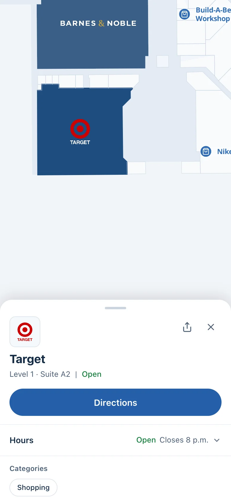 A store detail card on a phone, with the store's location on the map and a directions button.